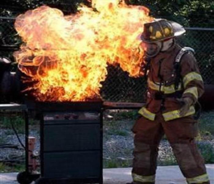 Grill on fire, firefighter on scene